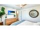 Relaxing bedroom featuring a rope mirror and a TV playing a relaxing beach scene, enhancing the room's ambiance at 5238 Susan Ave, Sarasota, FL 34231