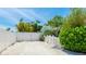 A driveway with white gravel and a white privacy fence leading to the home at 5238 Susan Ave, Sarasota, FL 34231