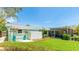 Charming home exterior featuring a screened-in porch, lush landscaping, and a private backyard at 5238 Susan Ave, Sarasota, FL 34231