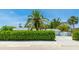 An inviting home exterior with lush landscaping and a grand palm tree in the front yard at 5238 Susan Ave, Sarasota, FL 34231