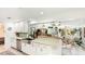 Bright kitchen featuring white cabinets, stainless steel appliances and breakfast bar open to a sunroom at 5238 Susan Ave, Sarasota, FL 34231