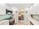 Kitchen with stainless steel appliances, tiled backsplash, and white cabinetry at 5238 Susan Ave, Sarasota, FL 34231