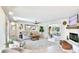 Bright living room featuring stylish furniture, a fireplace, tile flooring, and access to a sunroom at 5238 Susan Ave, Sarasota, FL 34231