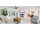 Open concept living room with a fireplace, tile flooring, and views into a sunroom at 5238 Susan Ave, Sarasota, FL 34231