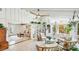 Inviting living room space with white walls, tile floors, bookshelves, and light-colored wicker furniture at 5238 Susan Ave, Sarasota, FL 34231