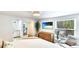 Main bedroom with wood floors, wicker dresser, and bathroom access at 5238 Susan Ave, Sarasota, FL 34231