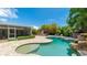 Stunning backyard with a pool, spa, rock waterfall, pergola, and screened lanai offers the ultimate outdoor experience at 5238 Susan Ave, Sarasota, FL 34231