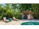 Charming poolside bar area with lounge chairs, perfect for outdoor entertaining at 5238 Susan Ave, Sarasota, FL 34231