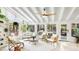 Bright sunroom featuring a vaulted ceiling, neutral furnishings, tile floors, and multiple windows bringing the outside in at 5238 Susan Ave, Sarasota, FL 34231