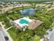 Aerial of community pool and lake surrounded by lush landscaping and luxurious homes at 5418 Fairfield Blvd, Bradenton, FL 34203