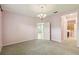 Bedroom with a light purple color scheme and views to an ensuite bathroom at 5418 Fairfield Blvd, Bradenton, FL 34203