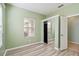 Bedroom with tile floors and a mirrored closet and a view of a window at 5418 Fairfield Blvd, Bradenton, FL 34203