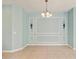 Dining room featuring decorative wall trim, sconces, and a chandelier at 5418 Fairfield Blvd, Bradenton, FL 34203