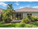 Exterior shot of the back of a home with a tile roof and a covered patio at 5418 Fairfield Blvd, Bradenton, FL 34203