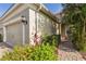 Home's exterior showcasing lush landscaping, a brick walkway, and neutral color palette at 5418 Fairfield Blvd, Bradenton, FL 34203