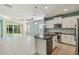 Spacious kitchen with white cabinets, a granite island, stainless steel appliances, and tile floors at 5418 Fairfield Blvd, Bradenton, FL 34203