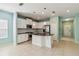 Bright kitchen featuring an island, stainless steel appliances, and a tile backsplash at 5418 Fairfield Blvd, Bradenton, FL 34203