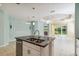 Open kitchen and living area with a granite island, tile flooring, and stainless steel appliances at 5418 Fairfield Blvd, Bradenton, FL 34203