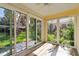 Bright sunroom with wood floors and sliding glass doors leading to the backyard at 5418 Fairfield Blvd, Bradenton, FL 34203