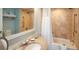 Clean, well-lit bathroom with a marble countertop, vanity, bathtub, and shower at 5500 Gulf Blvd # 6248, St Petersburg, FL 33706