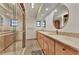 Bathroom with double sink vanity, granite countertops, framed mirrors, and tile shower at 5651 Golf Pointe Dr # 5651, Sarasota, FL 34243