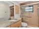 Tiled bathroom featuring a granite countertop, updated cabinets, and glass enclosed shower at 5651 Golf Pointe Dr # 5651, Sarasota, FL 34243