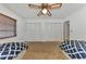 Comfortable bedroom showcases a closet and two twin beds with blue patterned bedspreads at 5651 Golf Pointe Dr # 5651, Sarasota, FL 34243