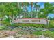 Welcoming Golf Pointe entrance sign surrounded by lush tropical landscaping, creating an appealing first impression at 5651 Golf Pointe Dr # 5651, Sarasota, FL 34243