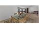 Spacious dining area with a glass table and views of the adjacent sunroom and pool table at 5651 Golf Pointe Dr # 5651, Sarasota, FL 34243