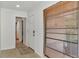Bright entryway features a white door, neutral tile flooring, and window with wood blinds, adding warmth to the space at 5651 Golf Pointe Dr # 5651, Sarasota, FL 34243