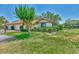 Charming single-story home with a red tile roof, well-manicured lawn, mature landscaping, and attached two-car garage at 5651 Golf Pointe Dr # 5651, Sarasota, FL 34243