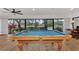 Enjoy a game of pool in this room, boasting views of the water at 5651 Golf Pointe Dr # 5651, Sarasota, FL 34243