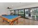 Entertaining game room featuring a pool table and stunning water views from the sliding glass doors at 5651 Golf Pointe Dr # 5651, Sarasota, FL 34243