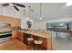 Kitchen with stainless steel appliances, granite countertops, and adjacent recreation room with pool table at 5651 Golf Pointe Dr # 5651, Sarasota, FL 34243