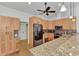 Kitchen with wooden cabinets, stainless steel appliances, and a breakfast bar overlooking the living area at 5651 Golf Pointe Dr # 5651, Sarasota, FL 34243