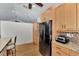 Bright kitchen with wood cabinets, granite countertops, stainless appliances, and wood flooring at 5651 Golf Pointe Dr # 5651, Sarasota, FL 34243