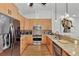 Stylish kitchen with granite counters, stainless appliances, and wooden cabinets at 5651 Golf Pointe Dr # 5651, Sarasota, FL 34243