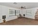 Spacious living room with neutral paint, ceiling fan and large windows providing ample natural light at 5651 Golf Pointe Dr # 5651, Sarasota, FL 34243