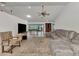 Open-concept living room with tile floors, comfortable seating, and a bright view of the outdoors at 5651 Golf Pointe Dr # 5651, Sarasota, FL 34243