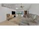 Open-concept living room featuring tile floors, a ceiling fan, and sliding glass doors with a view of the outdoors at 5651 Golf Pointe Dr # 5651, Sarasota, FL 34243
