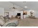 Open-concept living room with tile floors, modern furnishings, and a view of the kitchen and dining area at 5651 Golf Pointe Dr # 5651, Sarasota, FL 34243