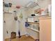 Pantry with shelving, cleaning supplies and food storage creating an organized space at 5651 Golf Pointe Dr # 5651, Sarasota, FL 34243