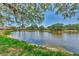 Scenic view of the expansive pond and surrounding lush community, with mature trees at 5651 Golf Pointe Dr # 5651, Sarasota, FL 34243