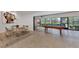 Dining area next to a sunroom and pool table with expansive views of the landscaped backyard and pond at 5651 Golf Pointe Dr # 5651, Sarasota, FL 34243