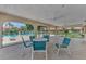 Inviting poolside lounge area with ceiling fans and comfortable seating, perfect for relaxing by the pool at 5651 Golf Pointe Dr # 5651, Sarasota, FL 34243