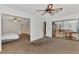 Sitting room with ceiling fan and view to the Primary bedroom and the billiards room at 5651 Golf Pointe Dr # 5651, Sarasota, FL 34243
