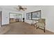 Carpeted sitting room with ceiling fan and view to the billiards room at 5651 Golf Pointe Dr # 5651, Sarasota, FL 34243