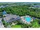 An aerial view of the community clubhouse, showcasing its proximity to a swimming pool and surrounding green spaces at 5735 Bungalow Grove Ct, Palmetto, FL 34221