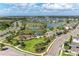 Aerial view of the community featuring a lake, playground, pool, picnic pavilion, and green spaces at 5735 Bungalow Grove Ct, Palmetto, FL 34221
