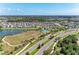 Community aerial view showcasing a lake, green spaces, walking paths, and residential areas at 5735 Bungalow Grove Ct, Palmetto, FL 34221